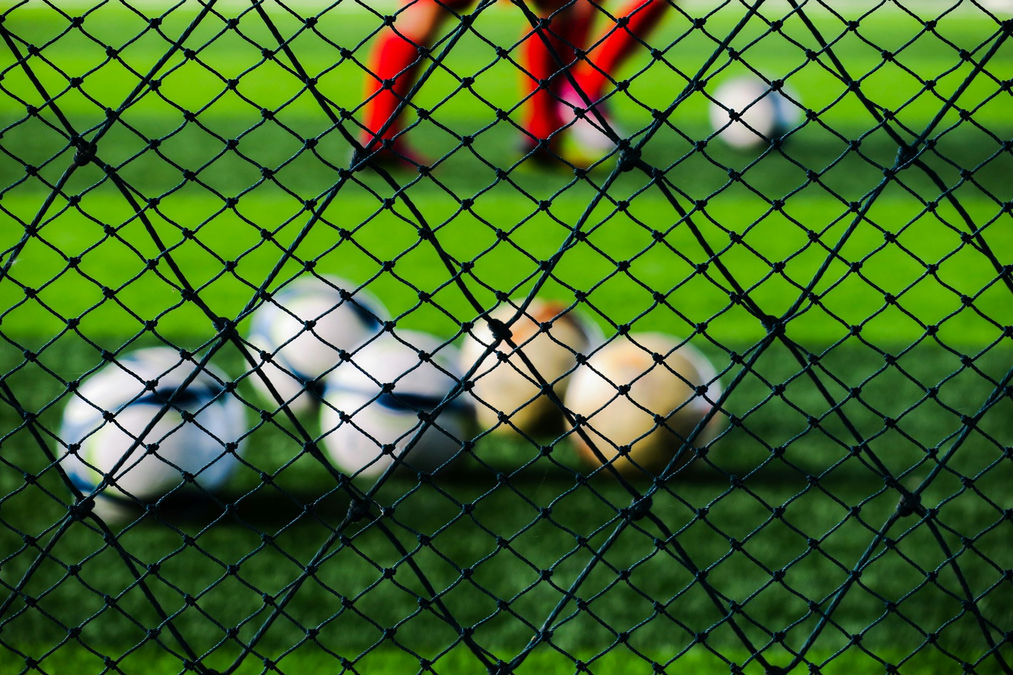 Blurry soccer ball on green field in sports stadium blur football team background. Back to school