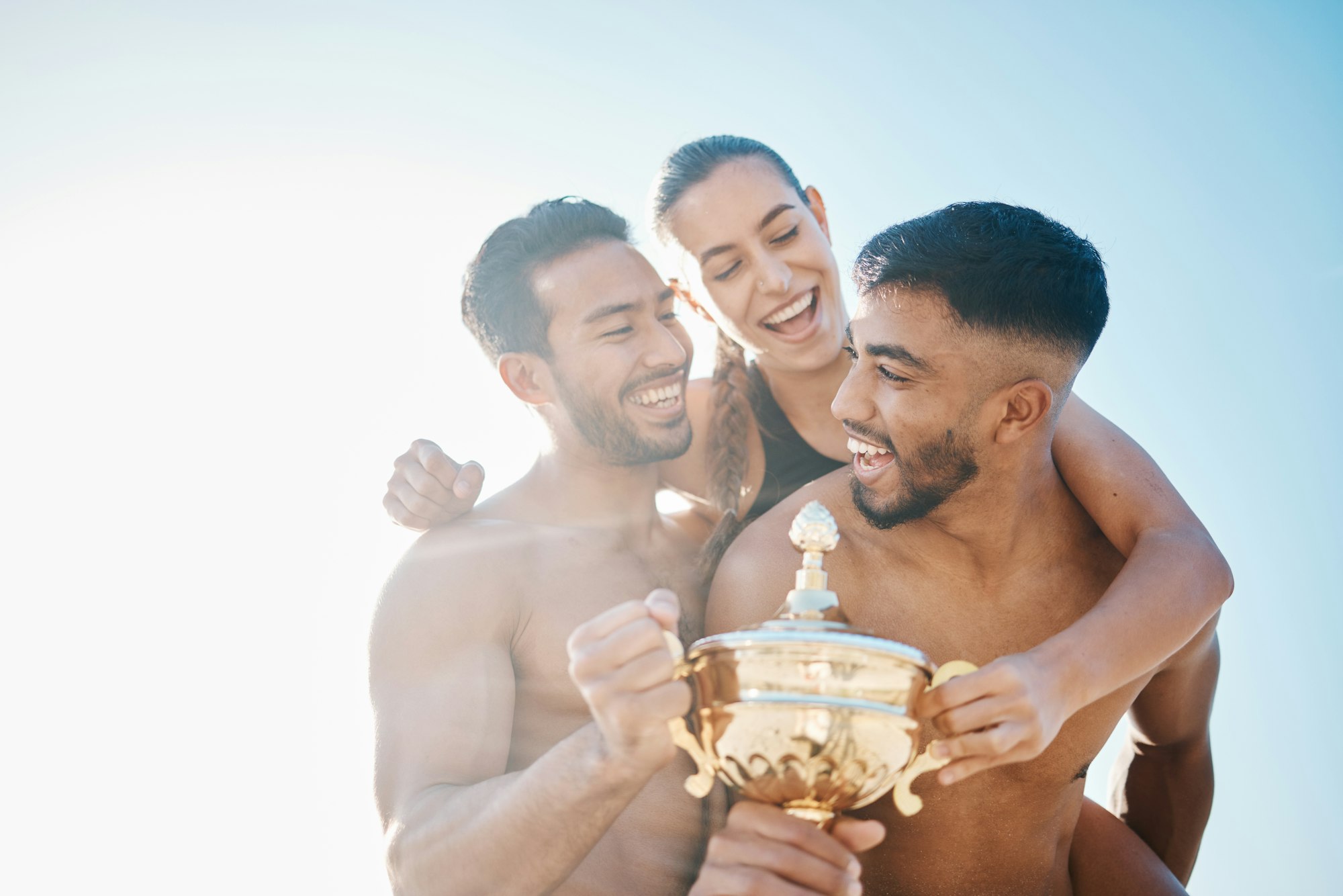 Celebration, winner and happy volleyball team on the beach with a trophy for goals, success or achi