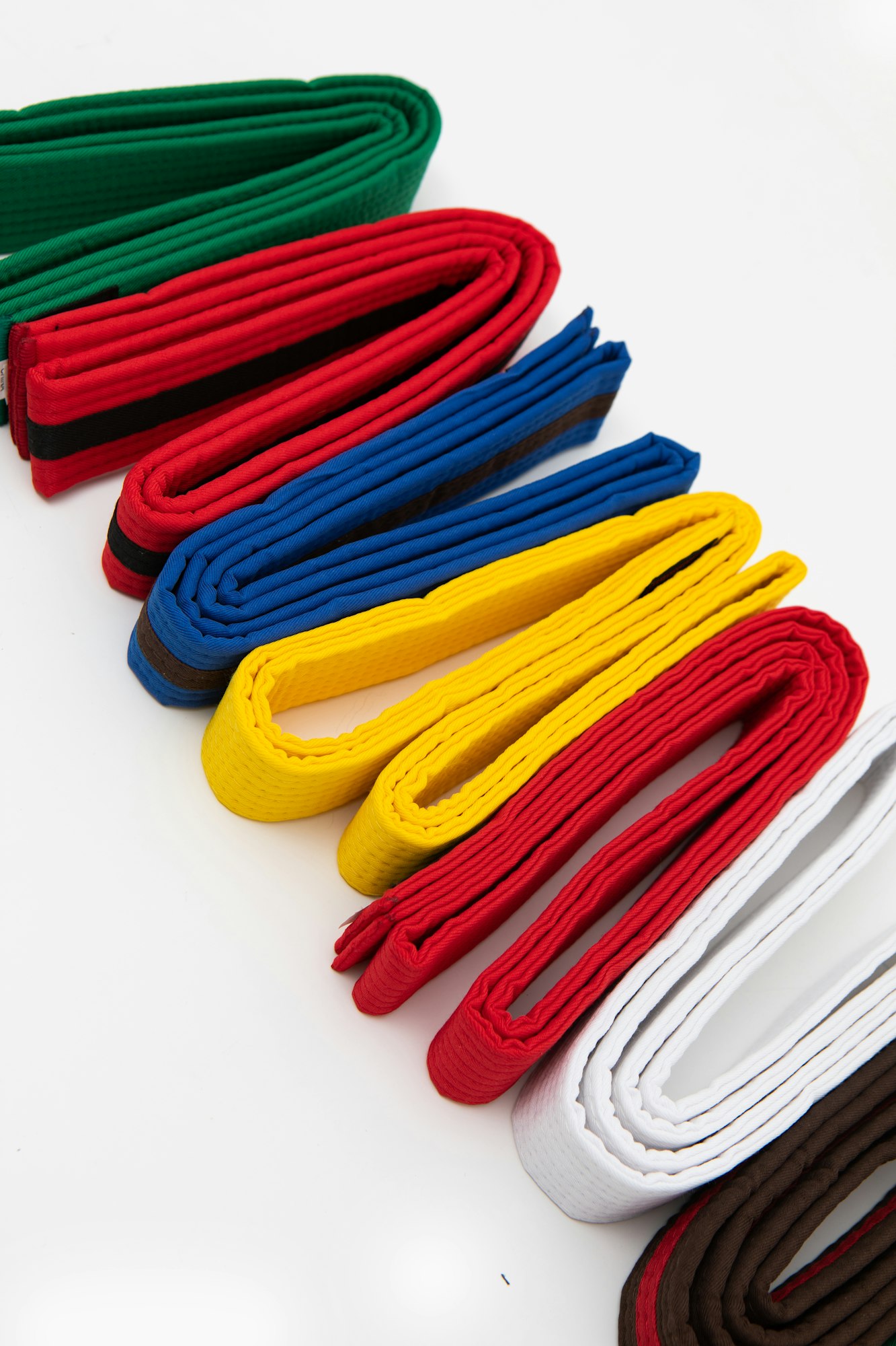 Closeup shot of colorful martial art belts on a white surface, South Korea