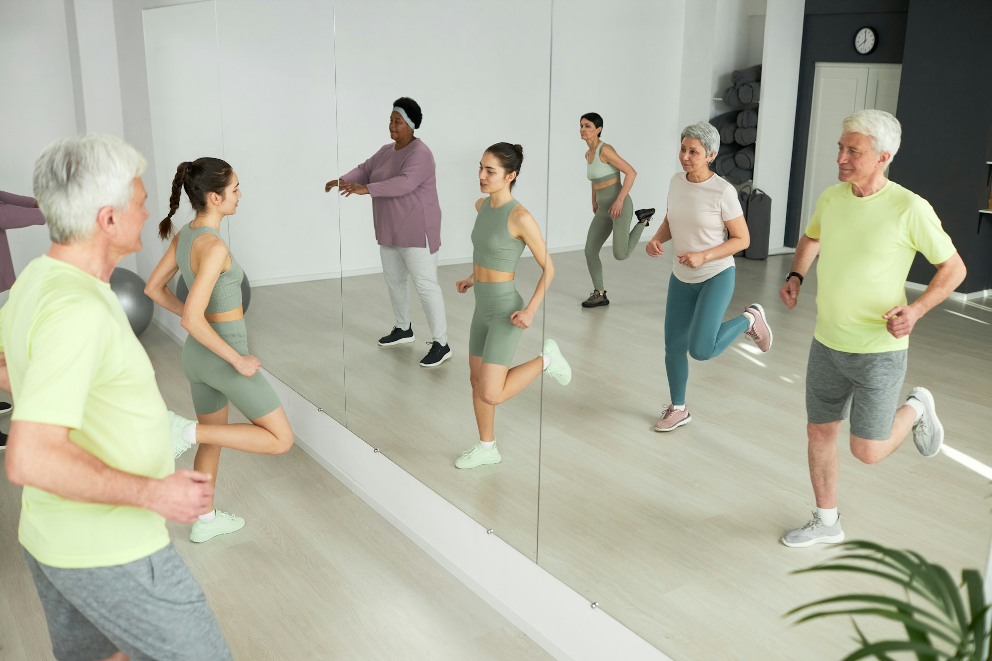 People doing gymnastics with coach